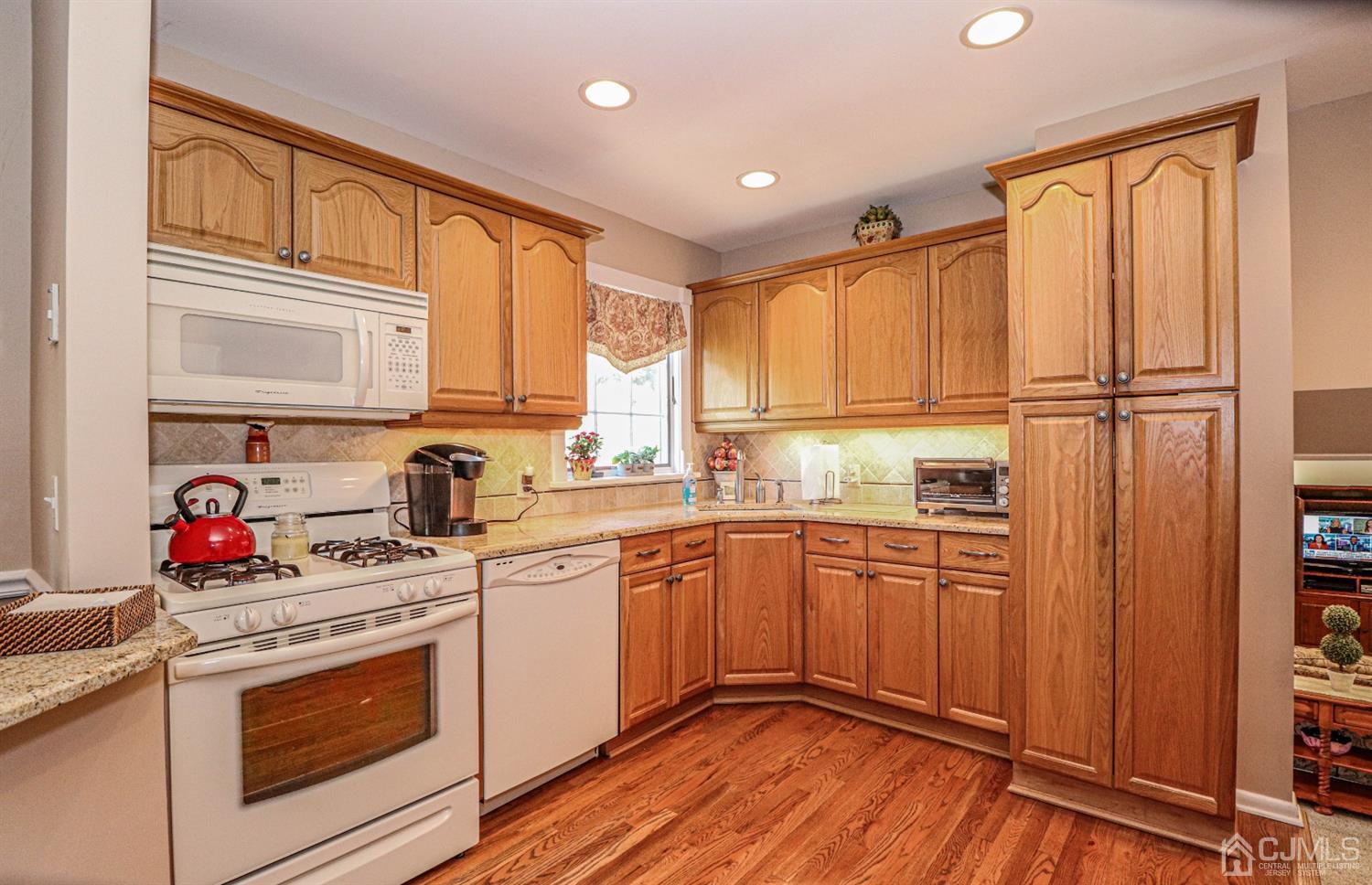 32 Monaghan Road Edison, NJ 08817 - Photo 13 of 35 a kitchen with stainless steel appliances granite countertop a sink stove and cabinets