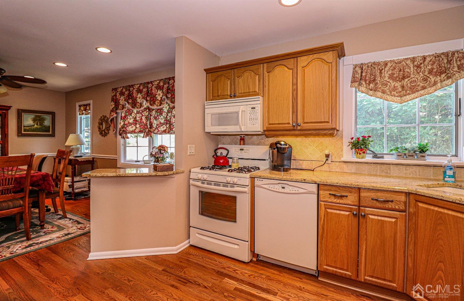 32 Monaghan Road Edison, NJ 08817 - Photo 14 of 35 a kitchen with stainless steel appliances granite countertop a stove a sink dishwasher and a microwave oven with cabinets