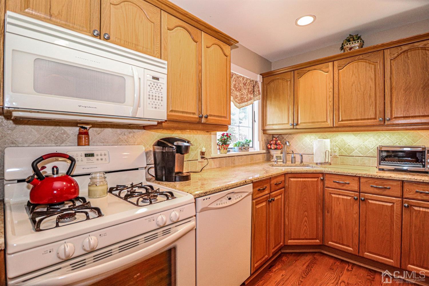 32 Monaghan Road Edison, NJ 08817 - Photo 18 of 35 a kitchen with kitchen island a sink cabinets and window