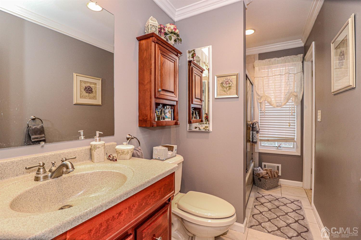 32 Monaghan Road Edison, NJ 08817 - Photo 21 of 35 a bathroom with a sink a toilet and shower curtain