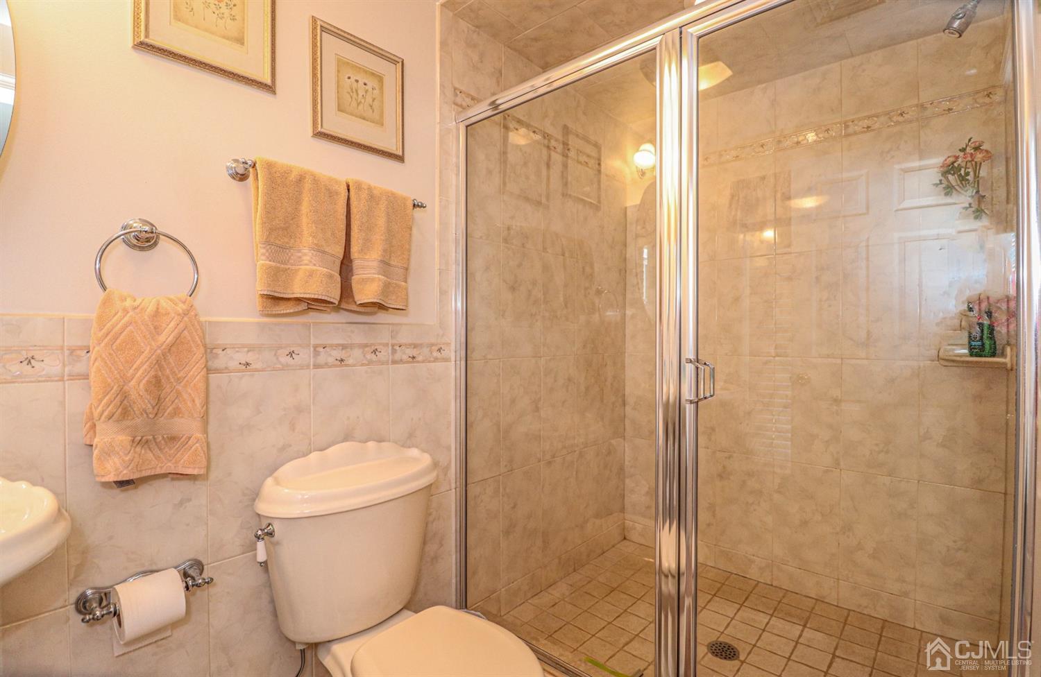 32 Monaghan Road Edison, NJ 08817 - Photo 22 of 35 a white toilet sitting next to a bathroom sink