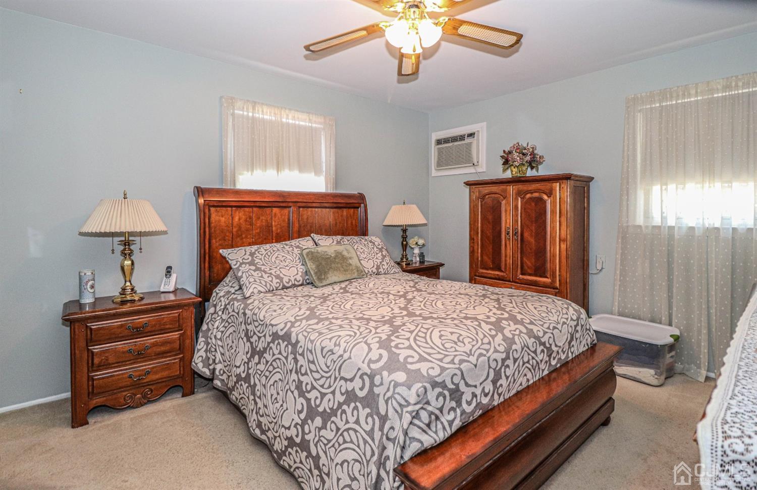 32 Monaghan Road Edison, NJ 08817 - Photo 23 of 35 a bedroom with bed and a lamp on dresser