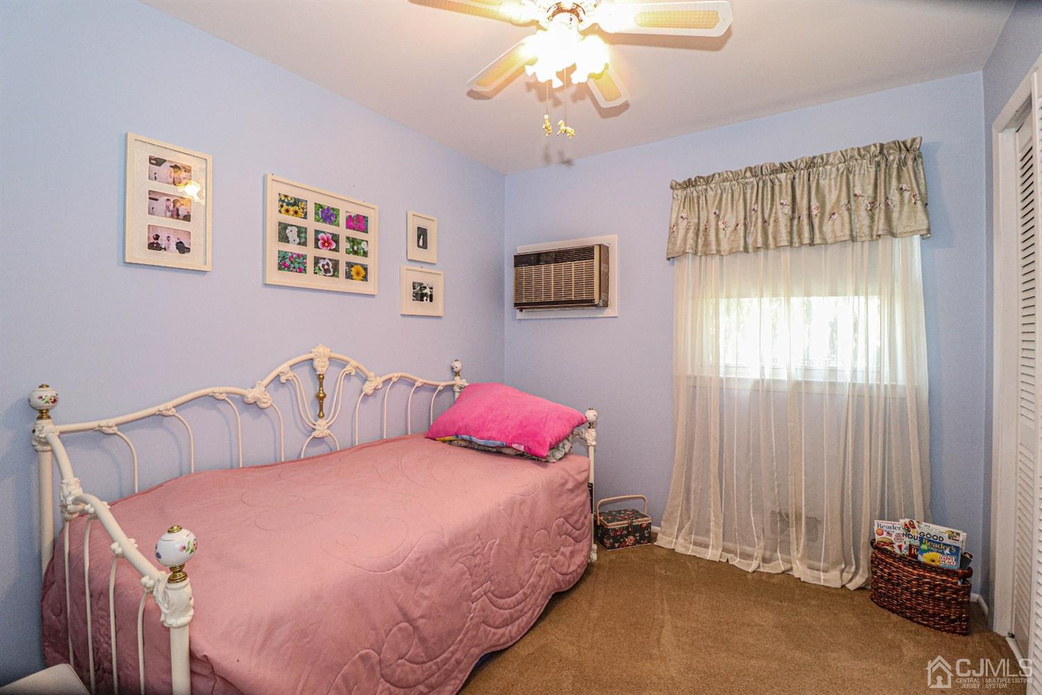 32 Monaghan Road Edison, NJ 08817 - Photo 25 of 35 a bedroom with a bed and a chandelier