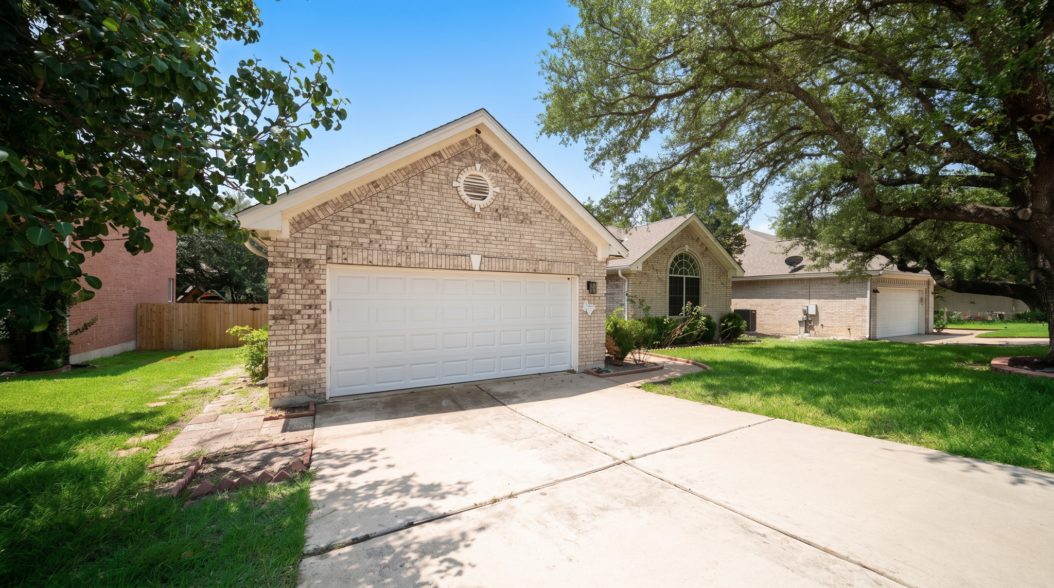 1108 Antelope Ridge Cedar Park, TX 78613 - Photo 18 of 27 Mature trees shade this charming brick home featuring an attached garage and a spacious concrete driveway.