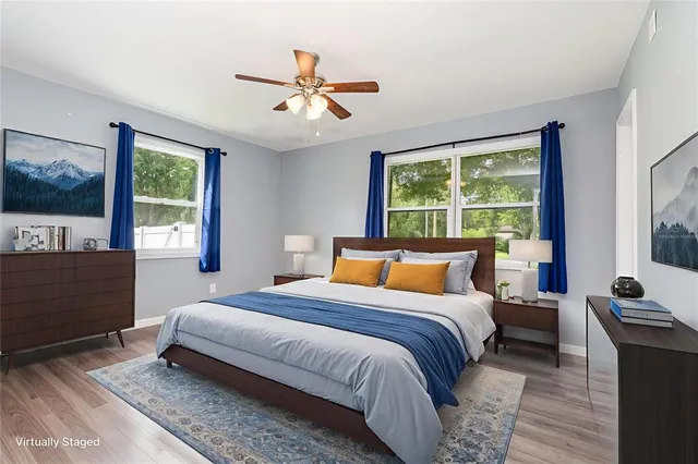 a bedroom with a large bed and a flat tv screen