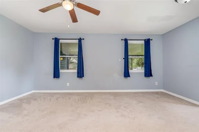 an empty room with windows and closet