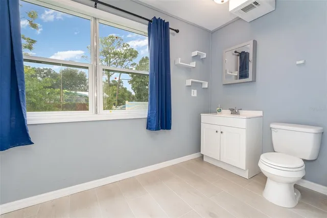 a white toilet sitting next to a bathroom sink