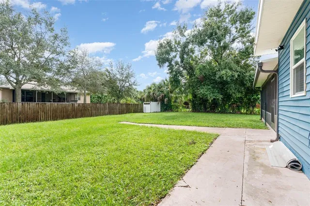 a view of a house with a yard and a patio