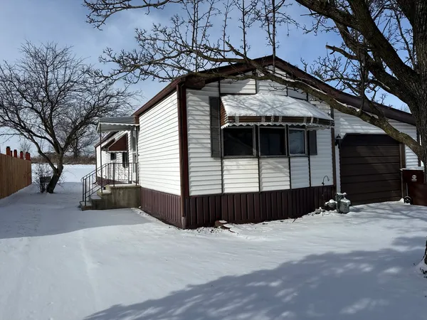 a view of a house with a snow in the yard