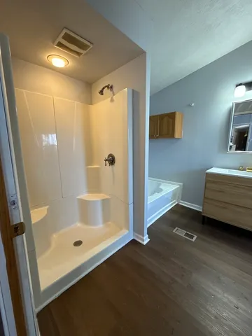a bathroom with a tub and a shower