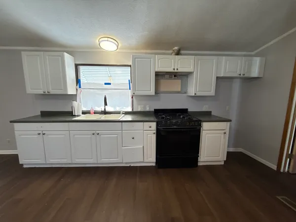 a kitchen with stainless steel appliances granite countertop a stove a sink dishwasher and a refrigerator