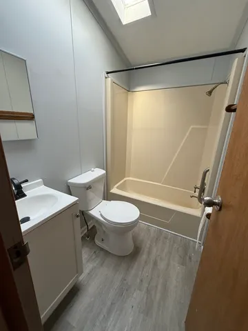 a bathroom with a toilet sink and shower
