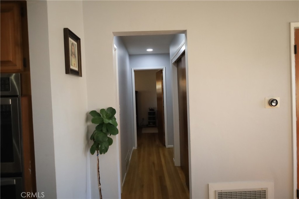 4389 Beverly Court Riverside, CA 92506 - Photo 11 of 14 a view of a hallway with wooden floor