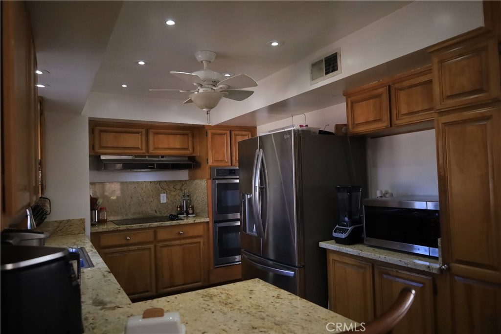 4389 Beverly Court Riverside, CA 92506 - Photo 12 of 14 a kitchen with a refrigerator and a sink