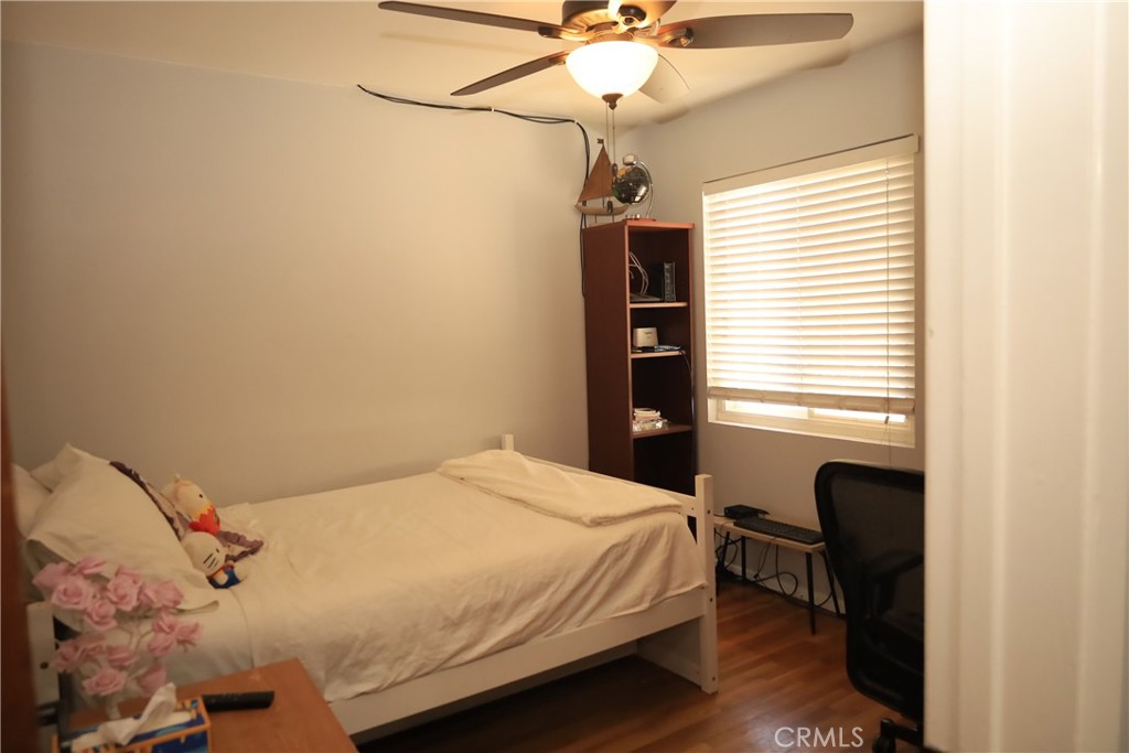 4389 Beverly Court Riverside, CA 92506 - Photo 7 of 14 a bedroom with a bed and a chandelier