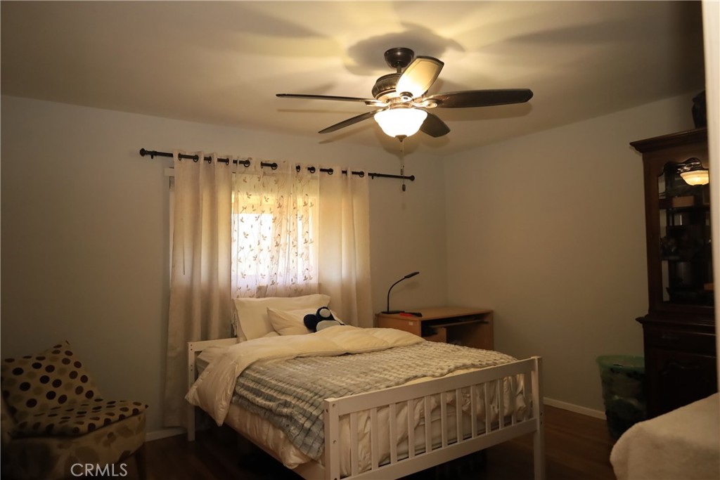 4389 Beverly Court Riverside, CA 92506 - Photo 8 of 14 a bedroom with a bed and a chandelier