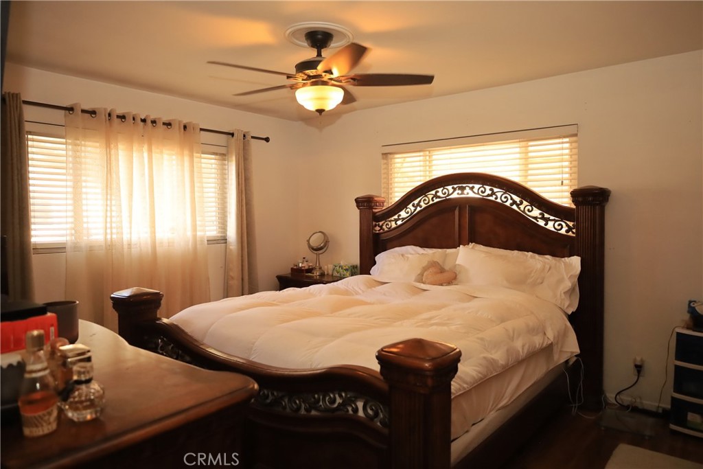4389 Beverly Court Riverside, CA 92506 - Photo 10 of 14 a bedroom with a bed and a chandelier