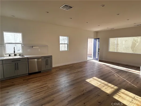 a kitchen with a refrigerator stove and white cabinets