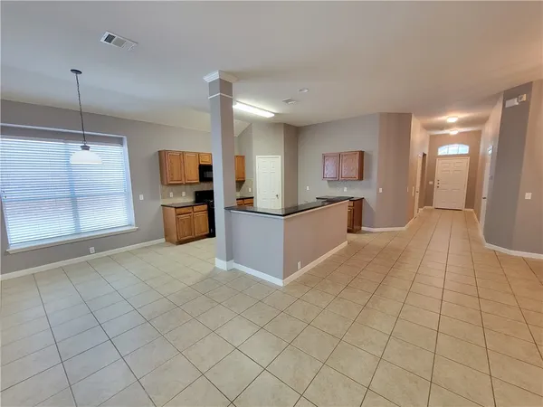 a view of a kitchen with a sink and cabinets