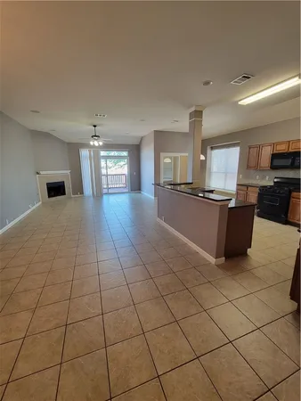 a large kitchen with cabinets and stainless steel appliances