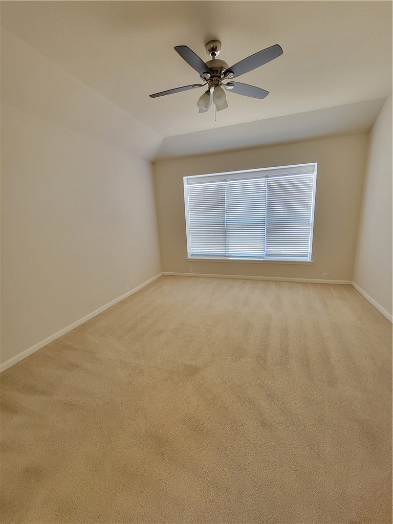 3526 Shiraz Loop Round Rock, TX 78665 - Photo 4 of 18 an empty room with a ceiling fan and a window