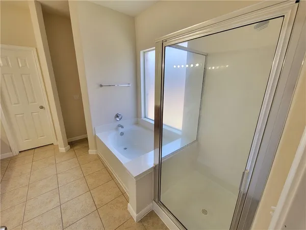 a bathroom with a bathtub and a shower