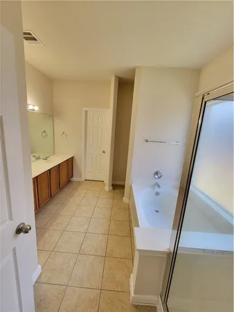 a bathroom with a sink a toilet and a large mirror