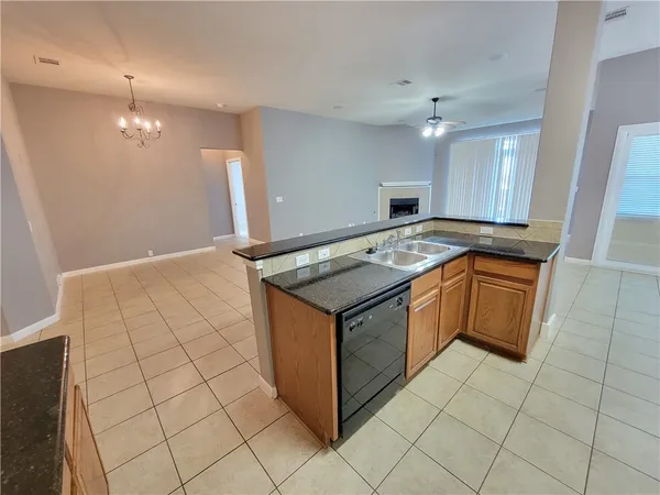 a kitchen with granite countertop a sink and cabinets