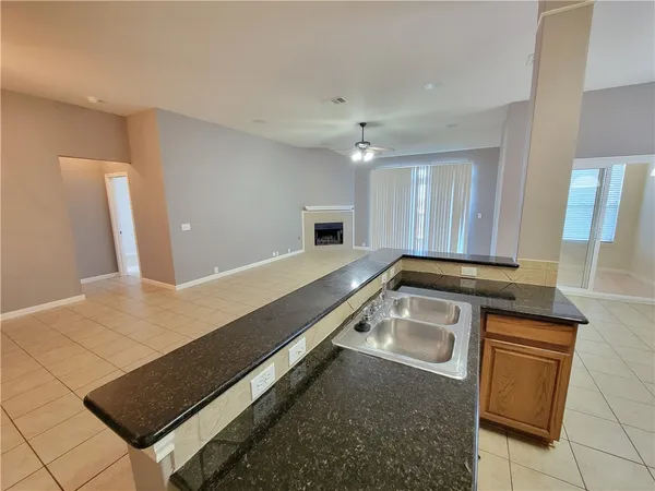 a kitchen with a sink and a refrigerator