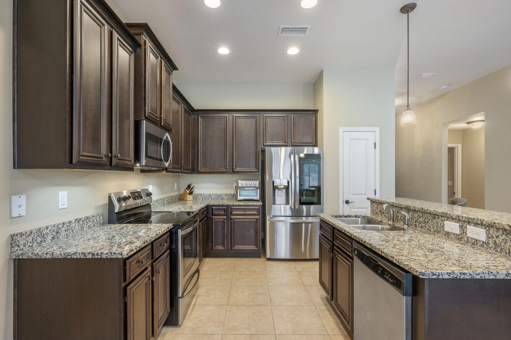 5811 Roberts Road Crestview, FL 32536 - Photo 13 of 35 a kitchen with stainless steel appliances granite countertop a sink a stove and a refrigerator