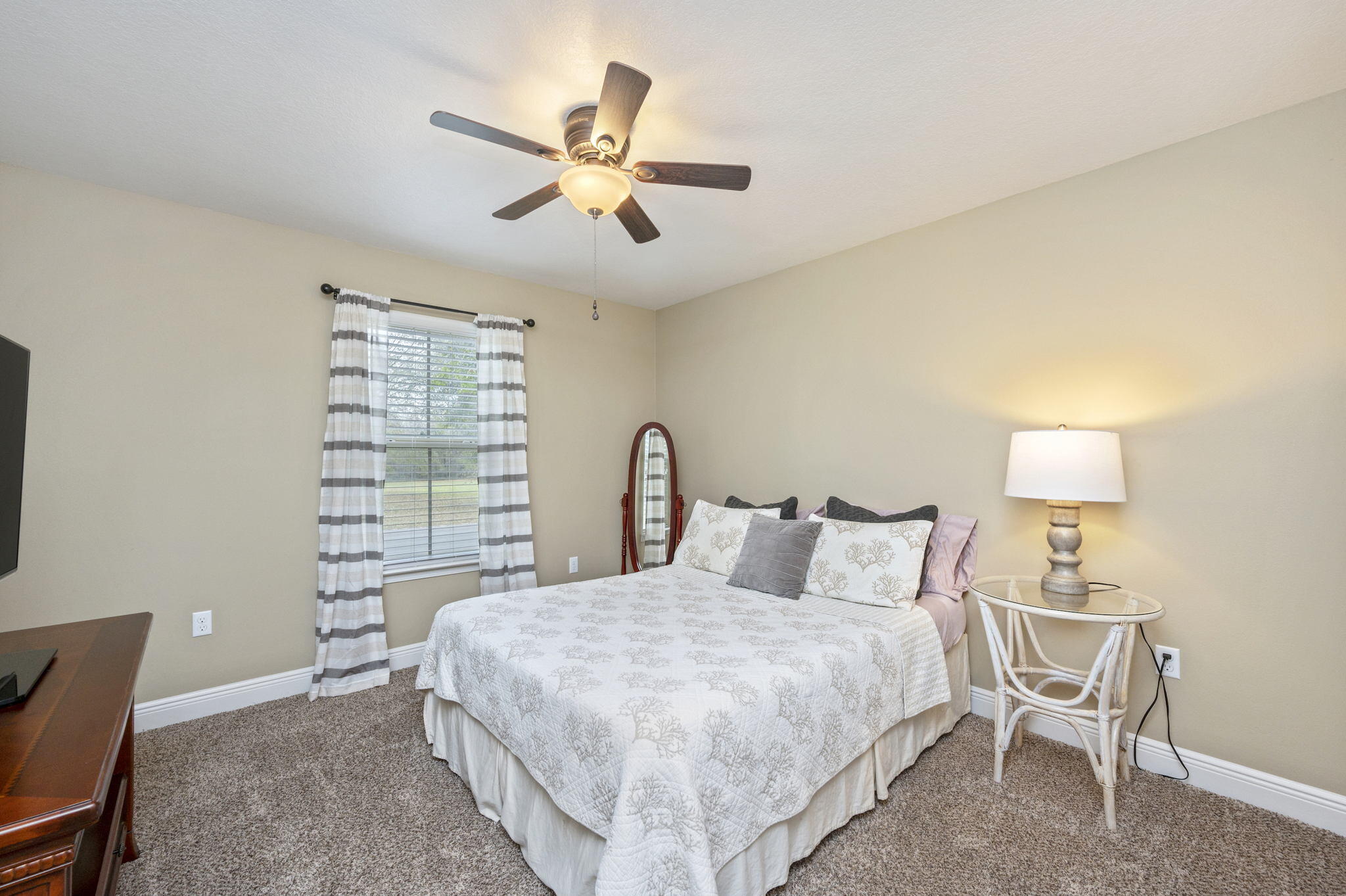 5811 Roberts Road Crestview, FL 32536 - Photo 25 of 35 a bedroom with a bed and a lamp on table
