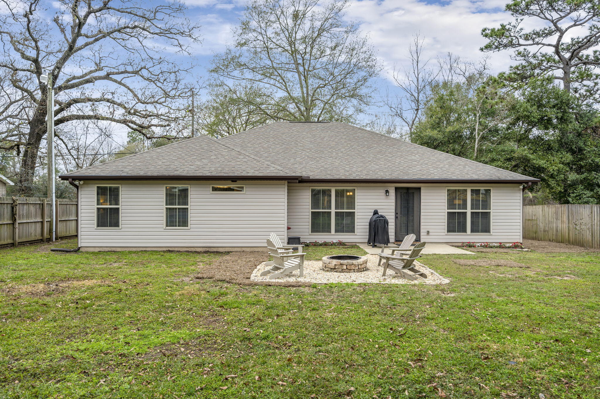5811 Roberts Road Crestview, FL 32536 - Photo 30 of 35 a front view of a house with a garden and patio