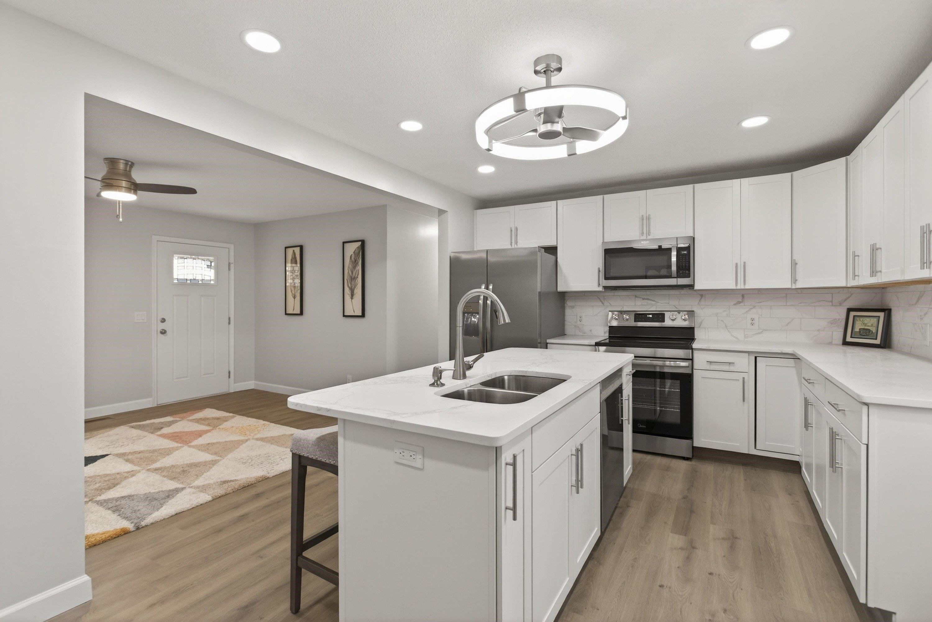 178 Suter Street Harrisonburg, VA 22802 - Photo 11 of 73 The completely renovated kitchen offers quartz counter-tops, luxury vinyl plank flooring, spacious kitchen island, white wooden cabinetry, recessed/modern light fixtures, and more!