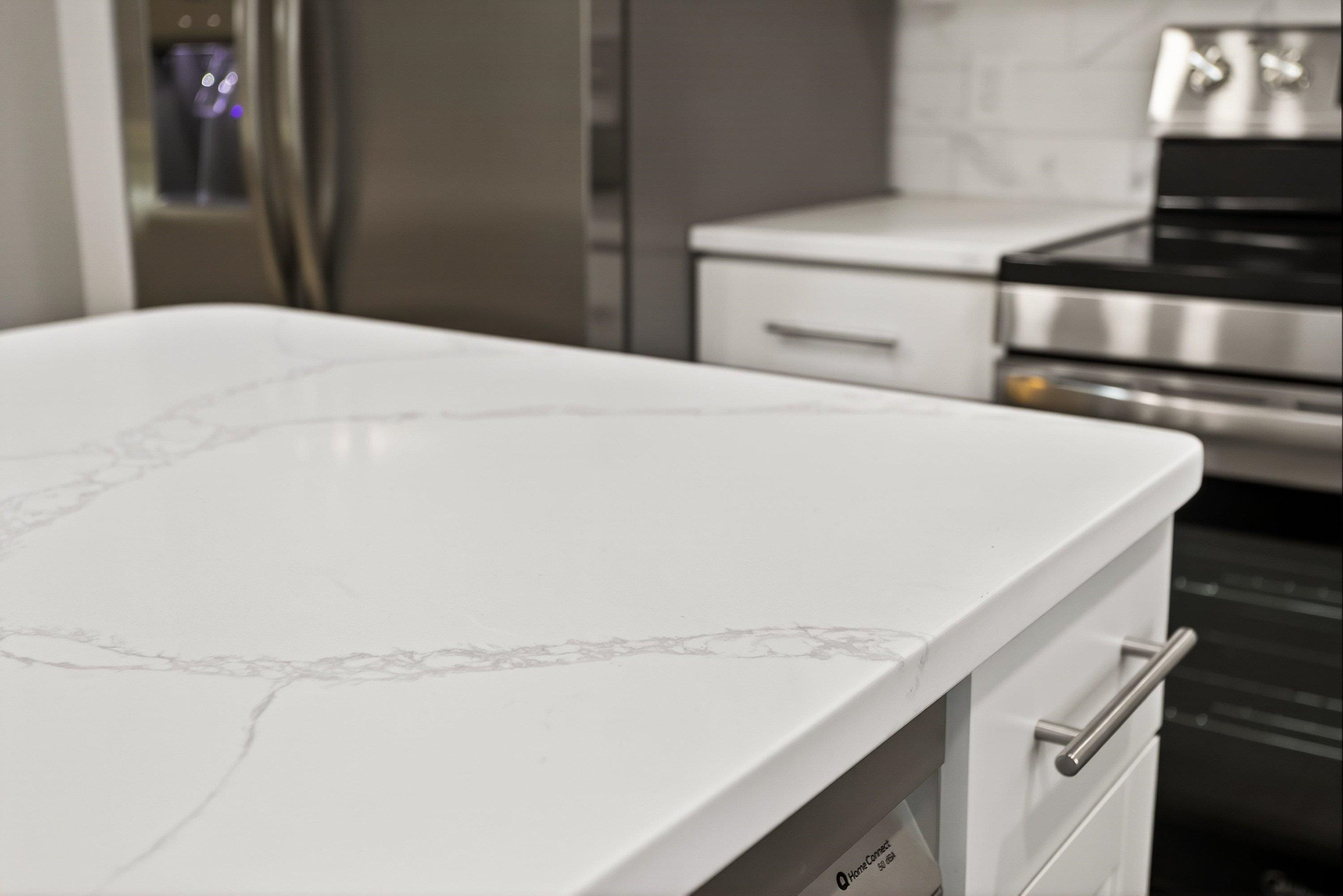 178 Suter Street Harrisonburg, VA 22802 - Photo 13 of 73 The completely renovated kitchen offers quartz counter-tops, luxury vinyl plank flooring, spacious kitchen island, white wooden cabinetry, recessed/modern light fixtures, and more!