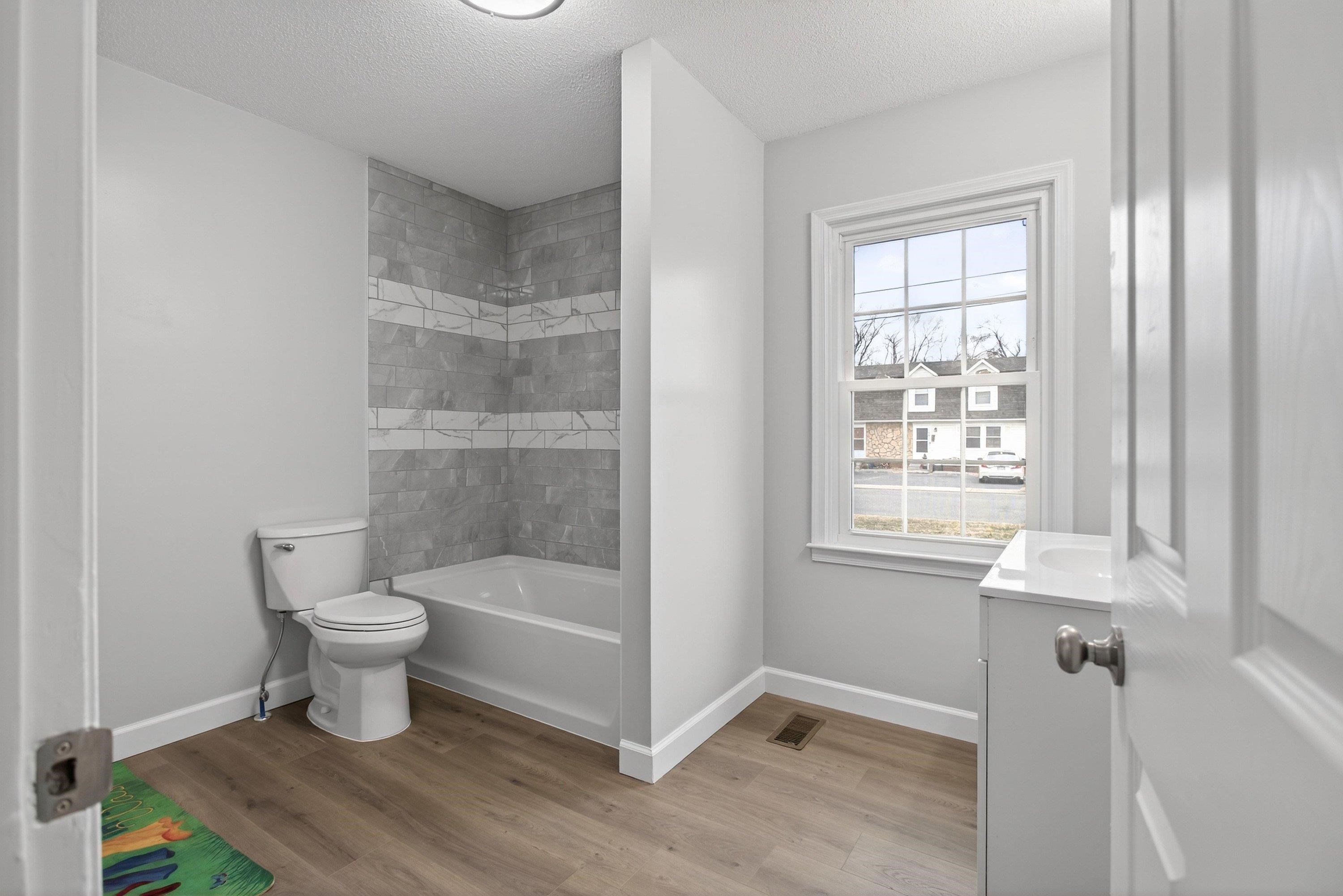 178 Suter Street Harrisonburg, VA 22802 - Photo 19 of 73 This spacious full bathroom offers a tile shower/bathtub area, luxury vinyl plank flooring, vanity with storage, and space for full-size washer & dryer hookups.