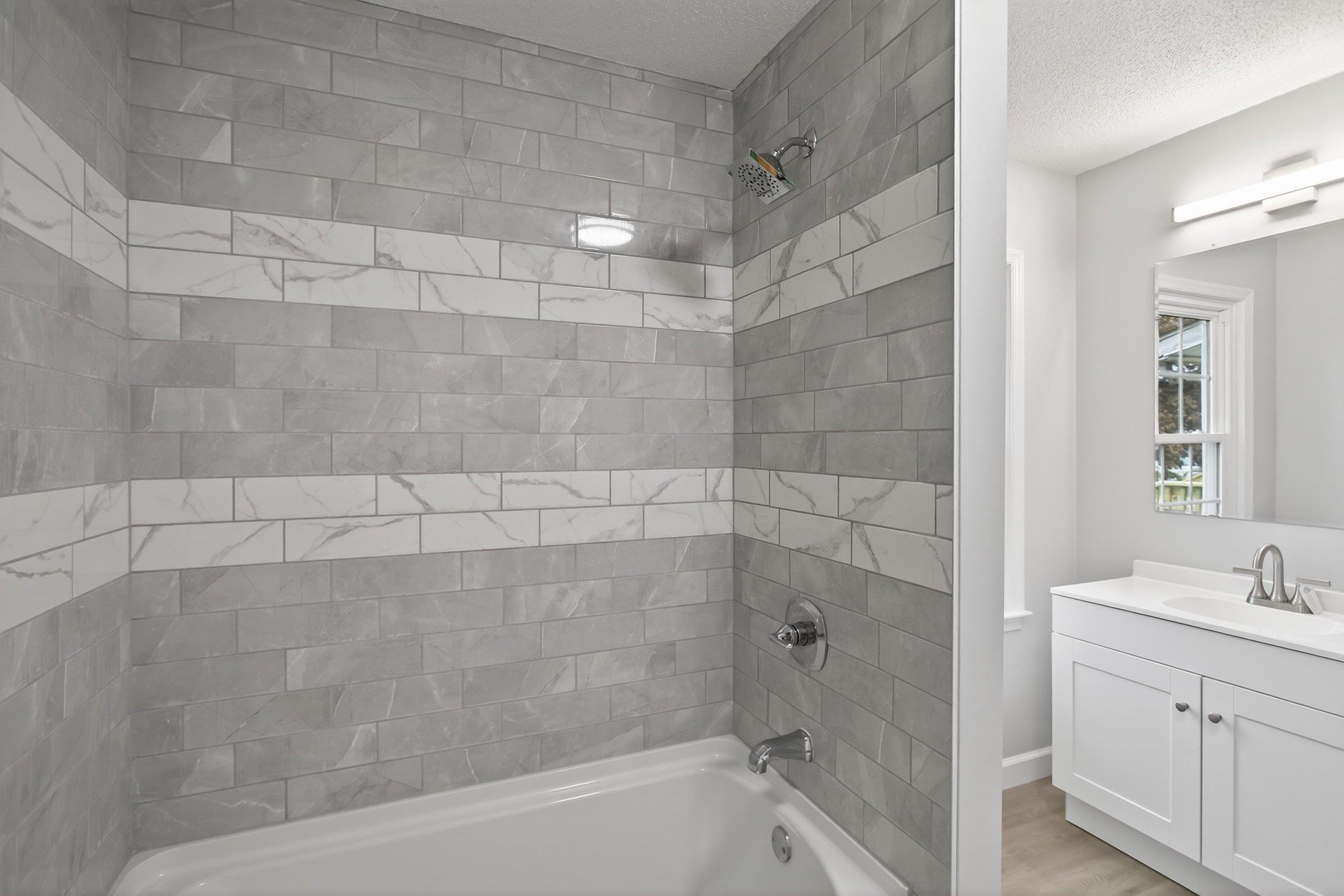 178 Suter Street Harrisonburg, VA 22802 - Photo 21 of 73 This spacious full bathroom offers a tile shower/bathtub area, luxury vinyl plank flooring, vanity with storage, and space for full-size washer & dryer hookups.