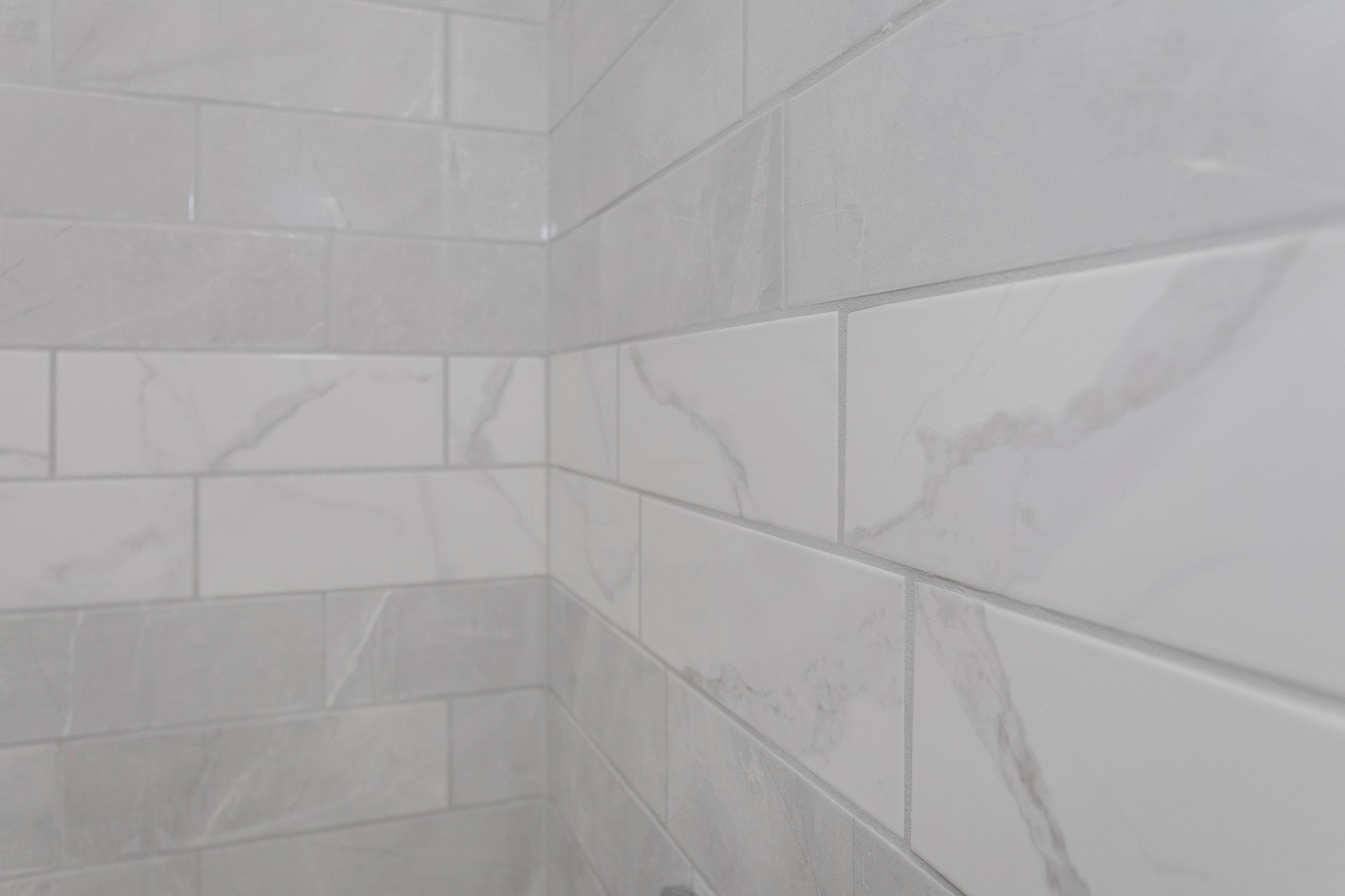 178 Suter Street Harrisonburg, VA 22802 - Photo 30 of 73 The primary bathroom offers a renovated vanity with storage cabinetry, luxury vinyl plank flooring, custom tile bathtub/shower space, and much more!