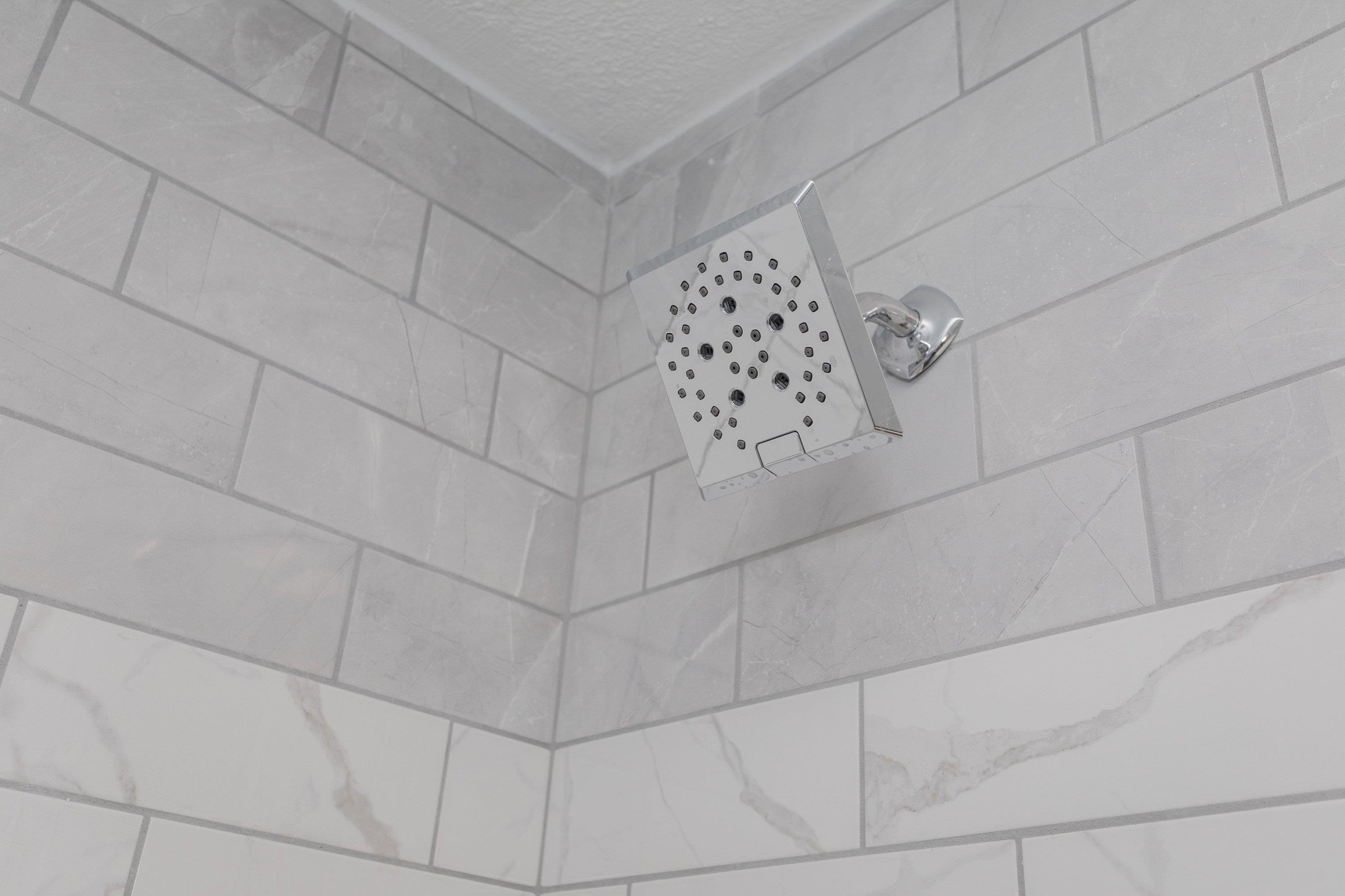 178 Suter Street Harrisonburg, VA 22802 - Photo 31 of 73 The primary bathroom offers a renovated vanity with storage cabinetry, luxury vinyl plank flooring, custom tile bathtub/shower space, and much more!