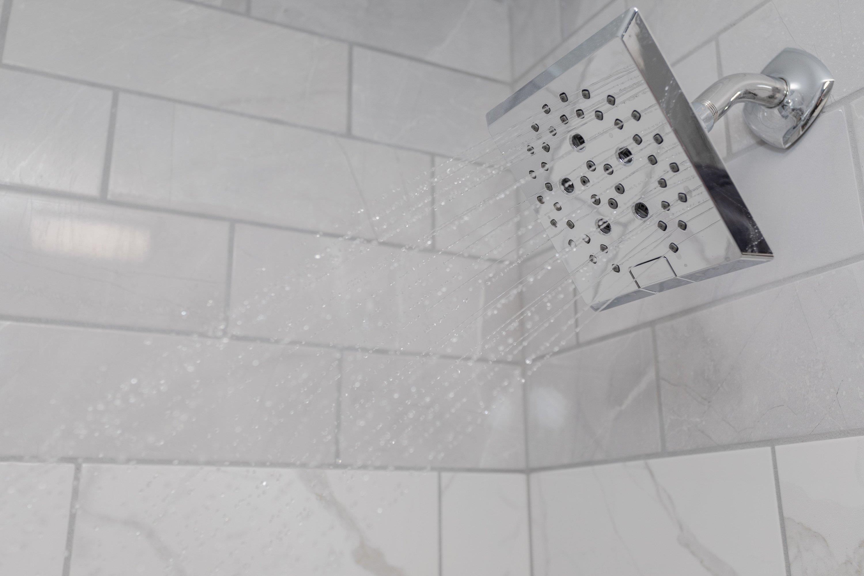 178 Suter Street Harrisonburg, VA 22802 - Photo 32 of 73 The primary bathroom offers a renovated vanity with storage cabinetry, luxury vinyl plank flooring, custom tile bathtub/shower space, and much more!