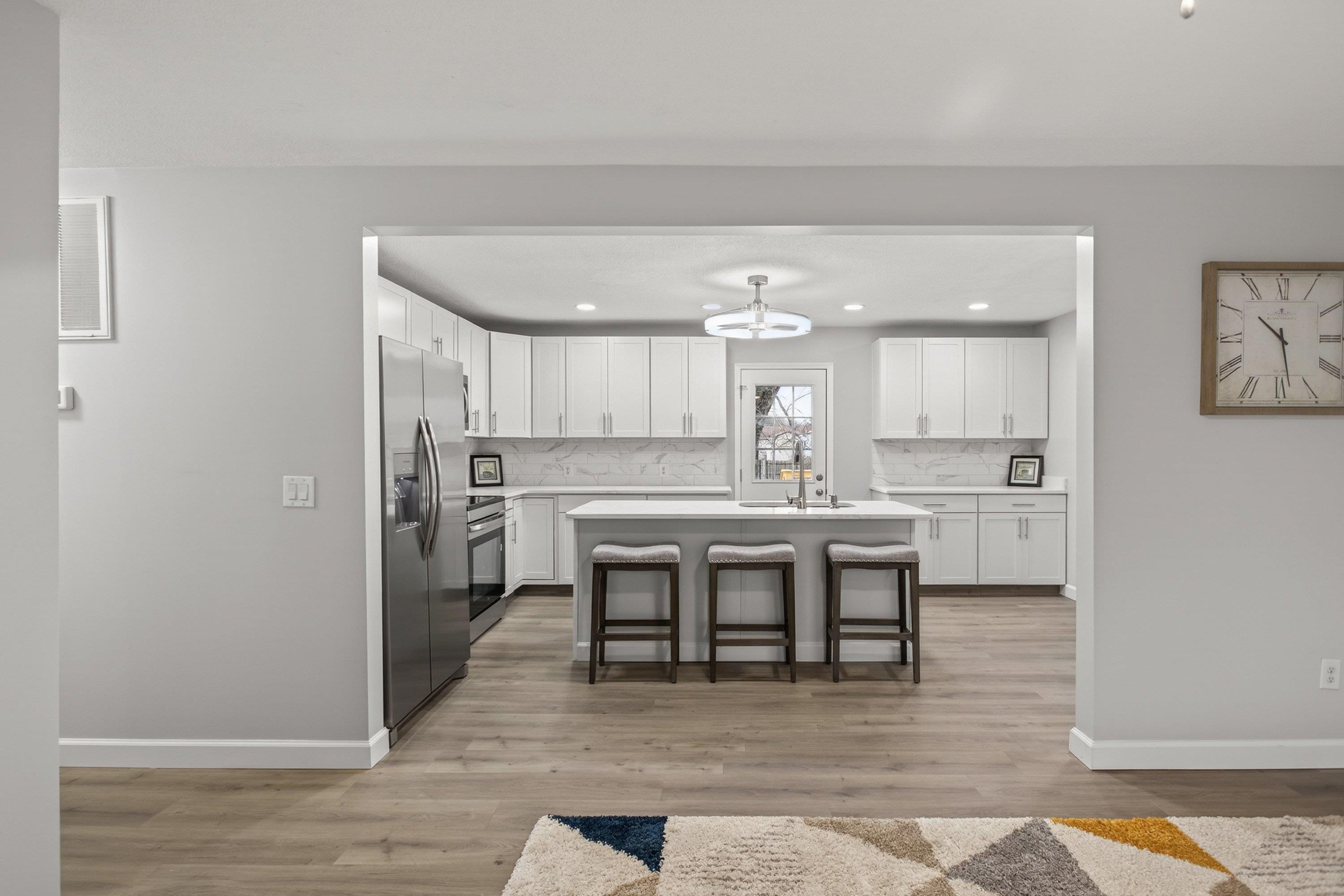 178 Suter Street Harrisonburg, VA 22802 - Photo 8 of 73 The living room is just inside the front door area. This open-concept, large space, features luxury vinyl plank flooring, a ceiling fan, new paint, large windows, and a large area for gathering with family and friends.