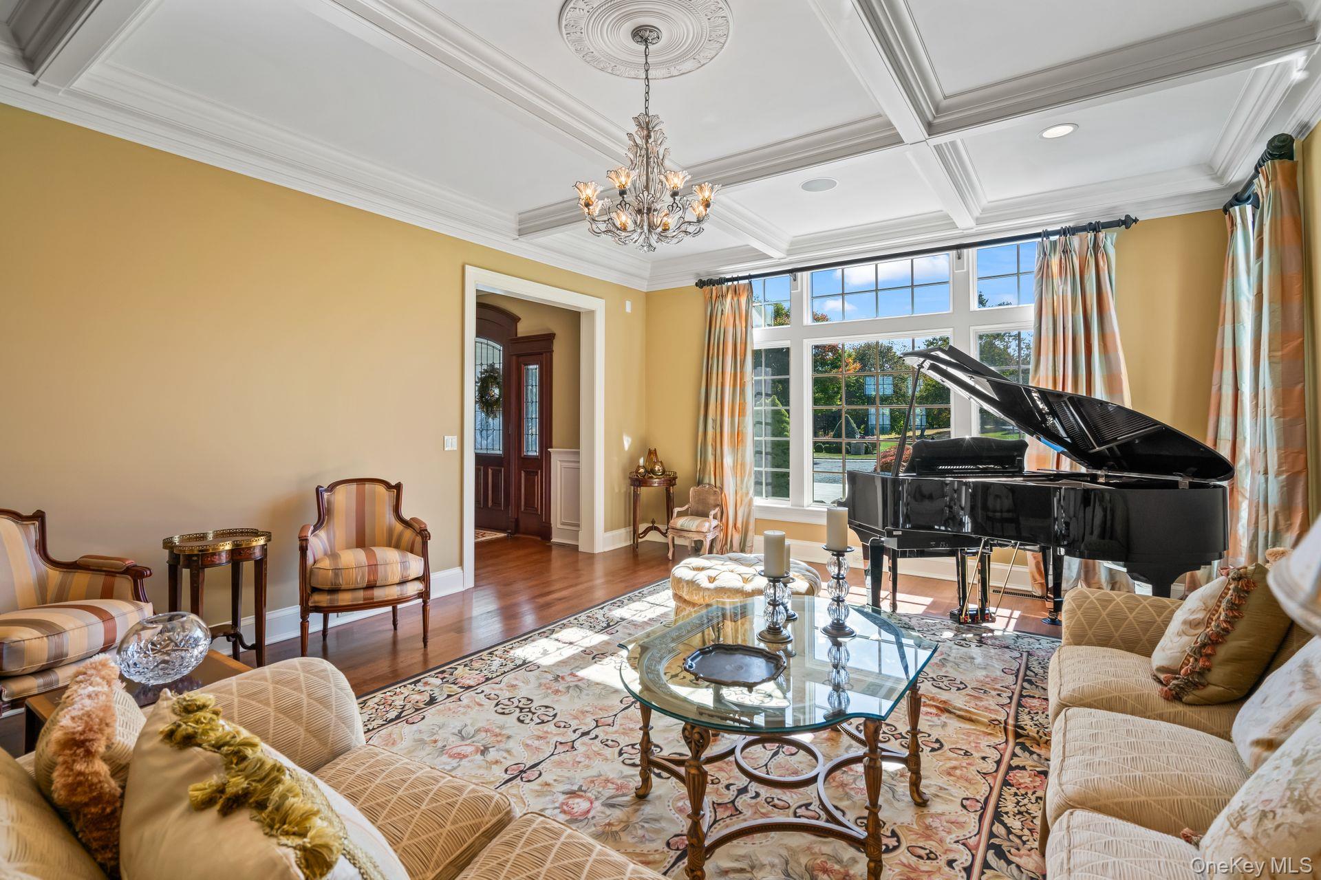 697 Short Beach Road Nissequogue, NY 11780 - Photo 11 of 46 a living room with furniture a chandelier and a large window