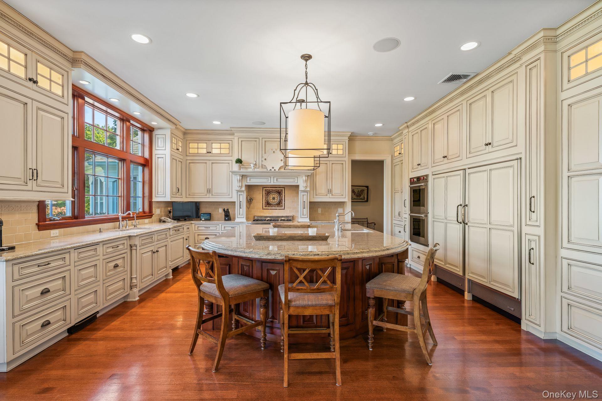 697 Short Beach Road Nissequogue, NY 11780 - Photo 16 of 46 a kitchen with stainless steel appliances kitchen island granite countertop a dining table chairs stove and white cabinets