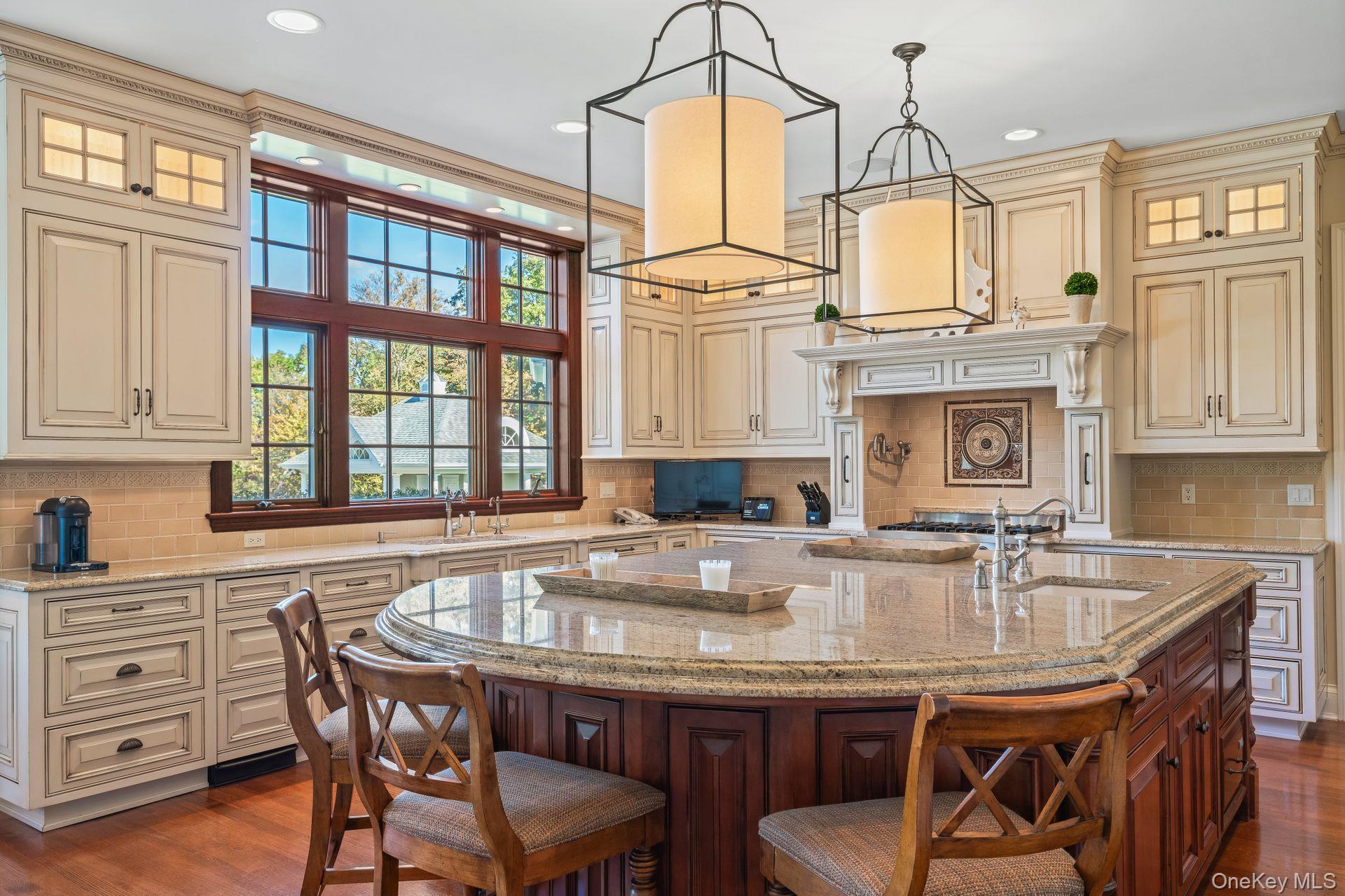 697 Short Beach Road Nissequogue, NY 11780 - Photo 17 of 46 a kitchen with granite countertop a table chairs stove and cabinets