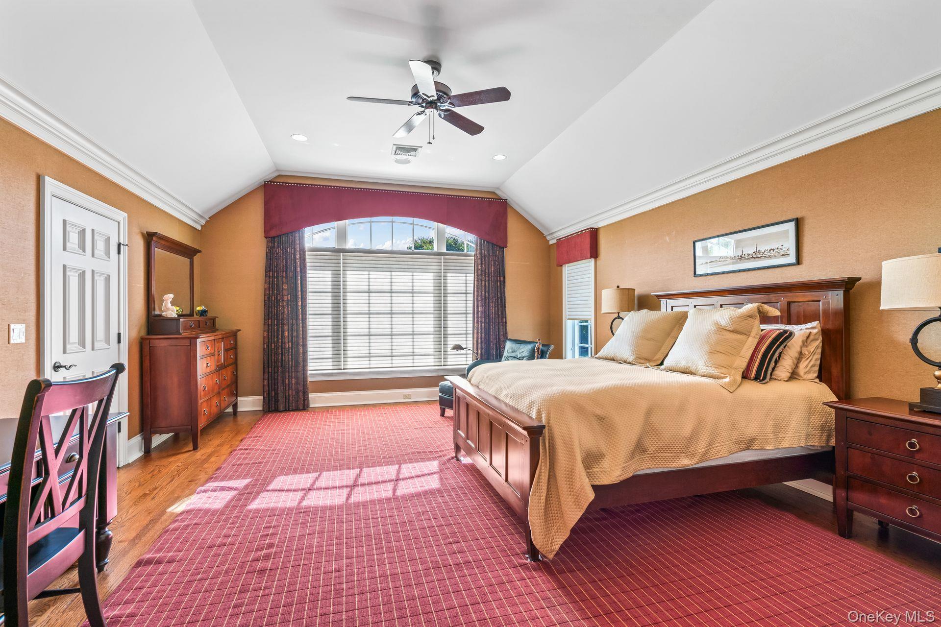 697 Short Beach Road Nissequogue, NY 11780 - Photo 29 of 46 a bedroom with a large bed and a chandelier