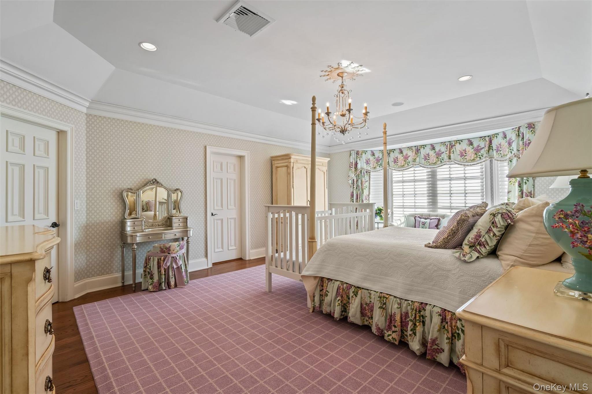 697 Short Beach Road Nissequogue, NY 11780 - Photo 31 of 46 a bedroom with a bed and a chandelier