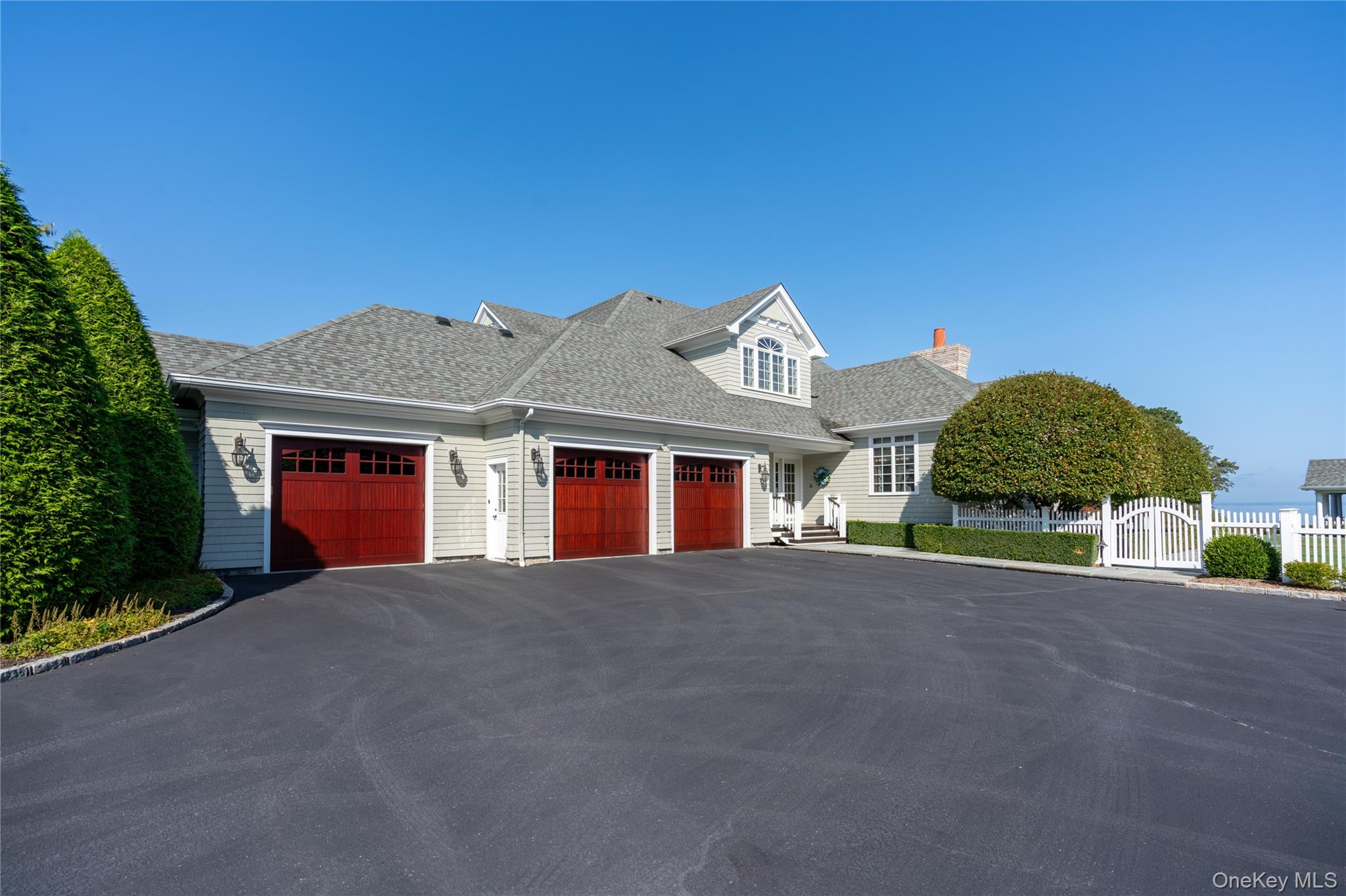 697 Short Beach Road Nissequogue, NY 11780 - Photo 37 of 46 a front view of a house with a yard and garage