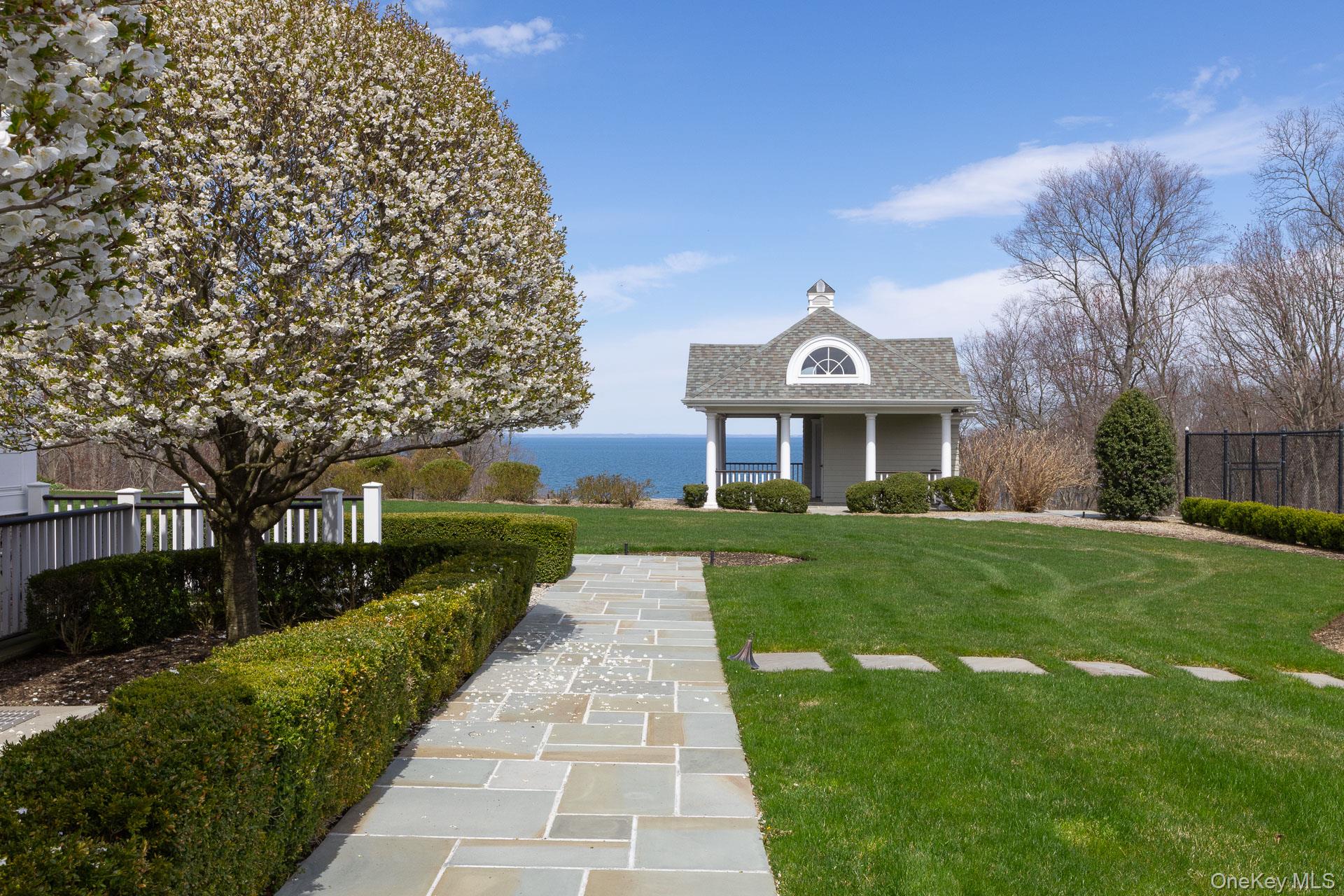 697 Short Beach Road Nissequogue, NY 11780 - Photo 40 of 46 a front view of a house with a yard