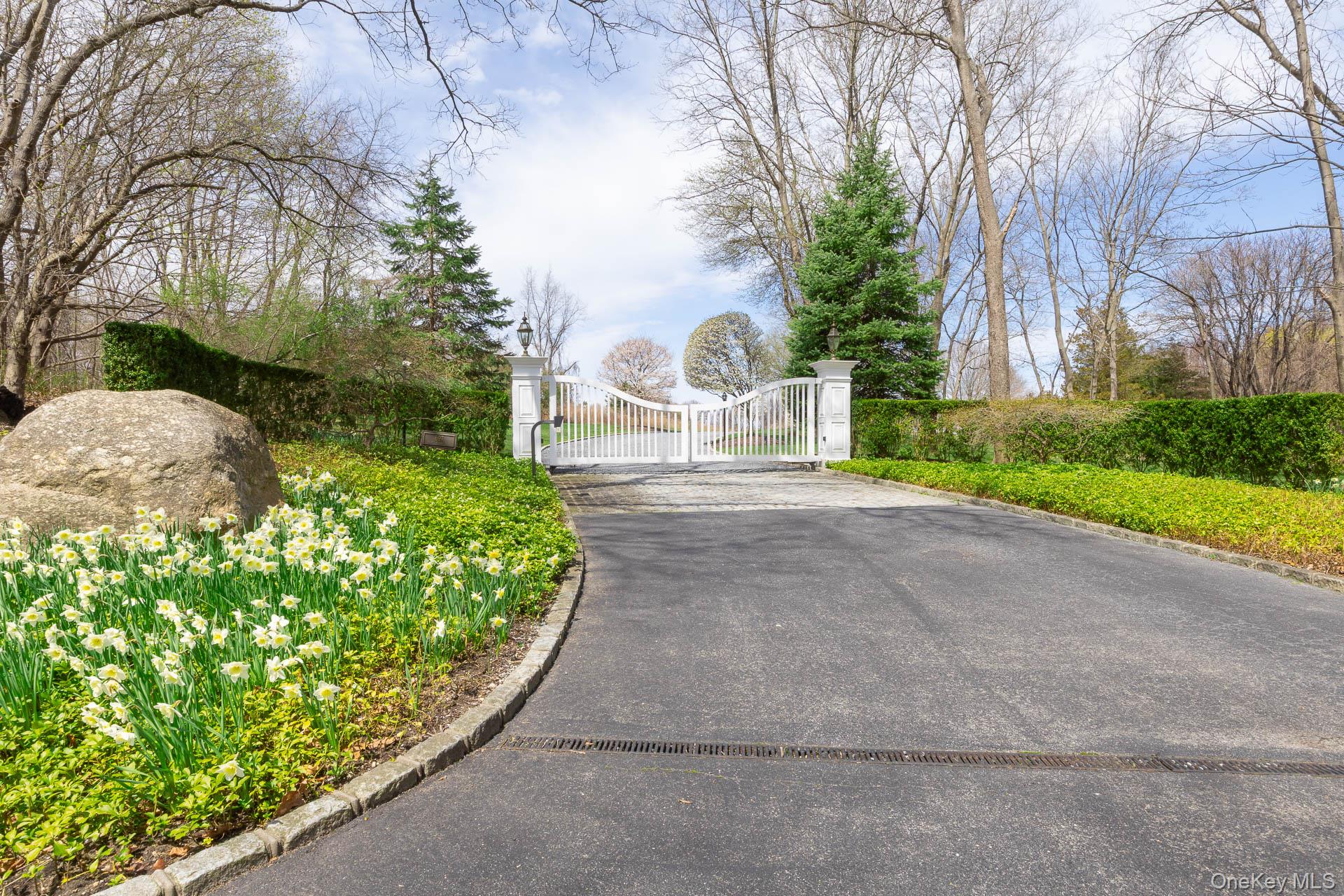 697 Short Beach Road Nissequogue, NY 11780 - Photo 4 of 46 a front view of a house with garden