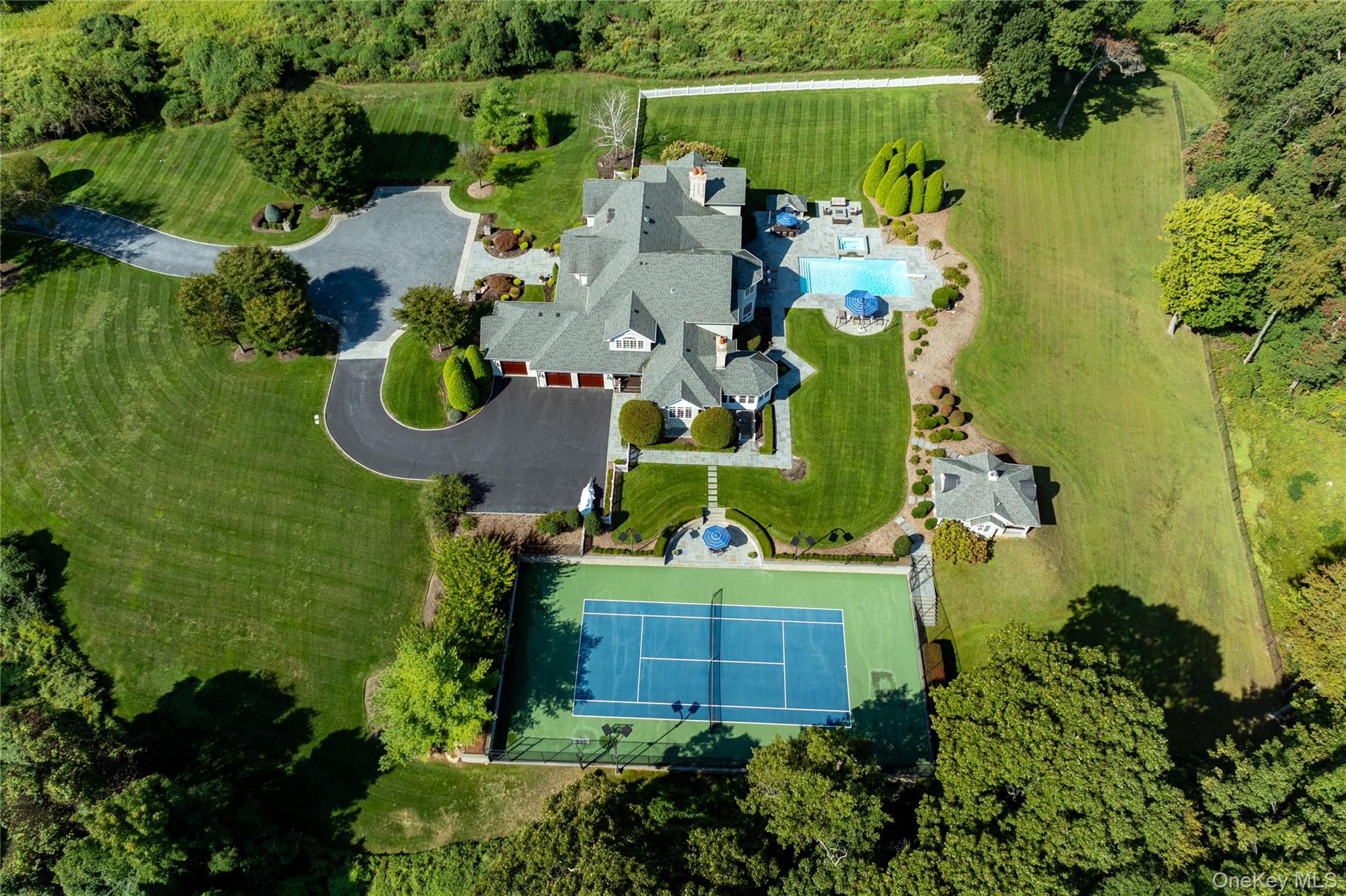 697 Short Beach Road Nissequogue, NY 11780 - Photo 44 of 46 an aerial view of a house with a swimming pool yard and outdoor seating