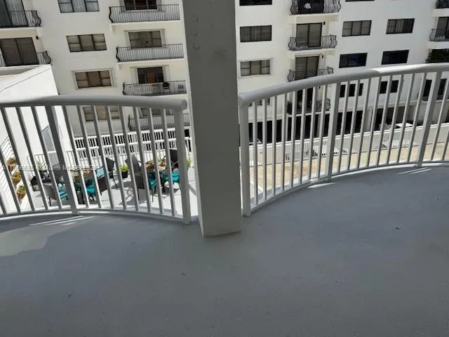 a view of a balcony with a floor to ceiling window